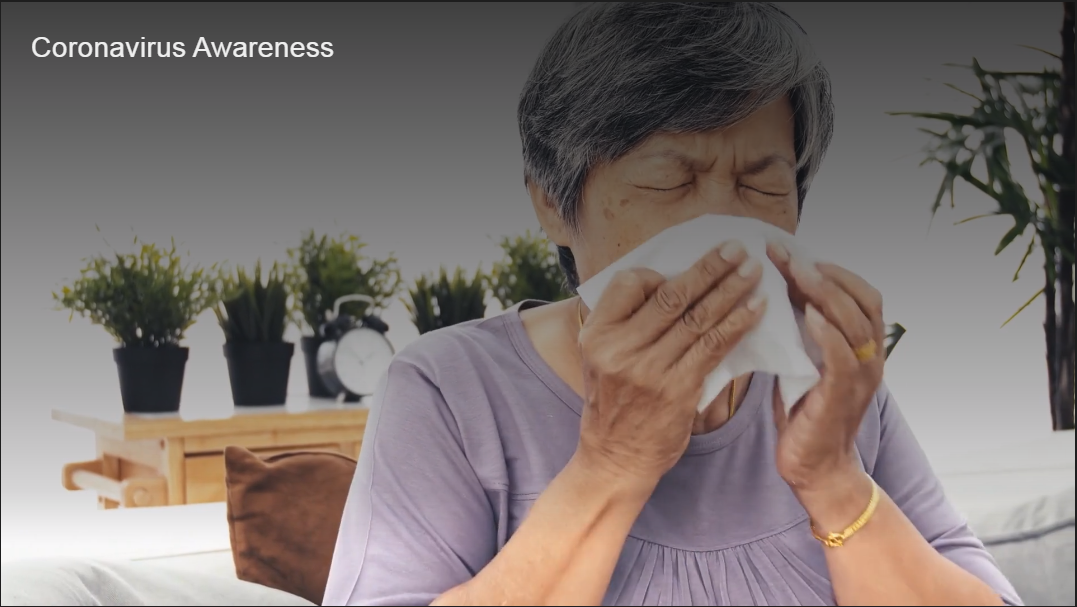 Woman sneezing into a tissue