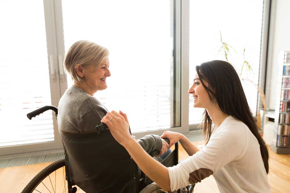 An Older Woman in a Wheelchair with an Ombudsman